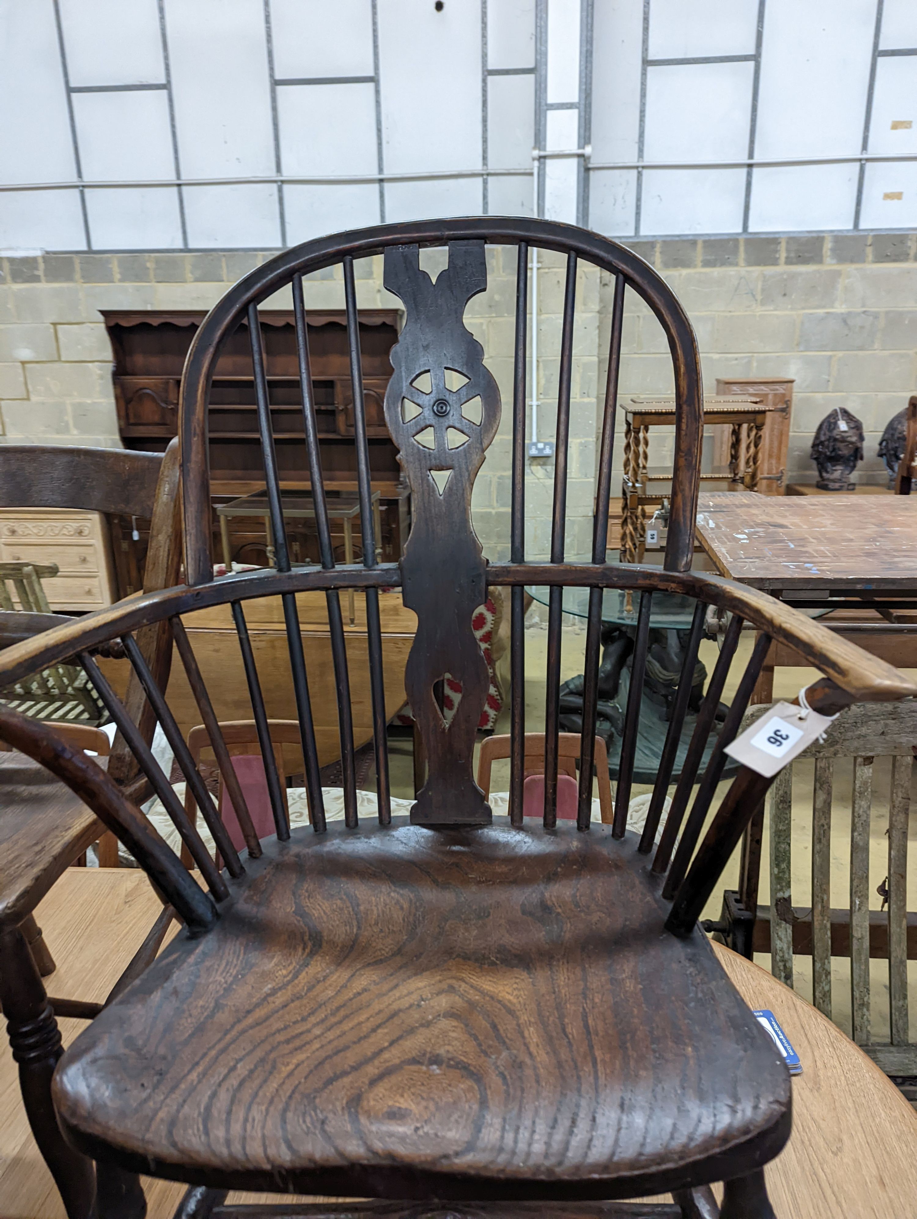 A mid 19th century Windsor ash and elm comb and wheelback armchair. H-104cm.